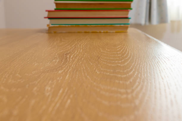 istock Wooden desk with stacked books 1318377582