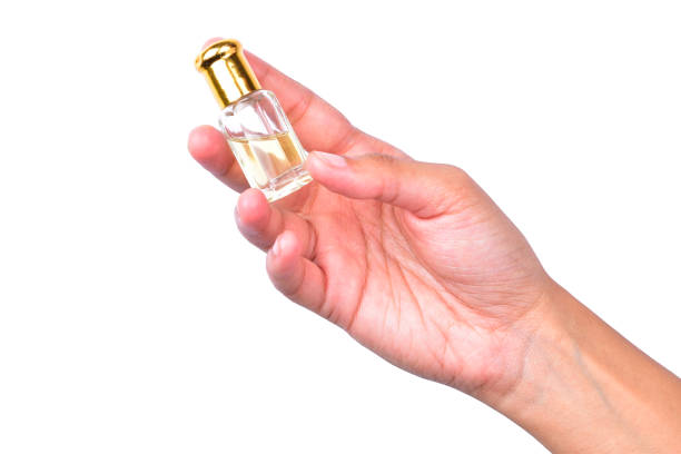 istock Essential Oil Bottle In Hand Isolated On White Background With Clipping Path 1318378911