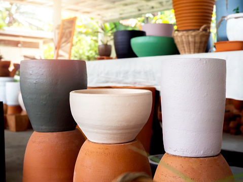 Round colorful ceramic and terracotta plant pots decoration in the shop. Empty geometric ceramic planter background.