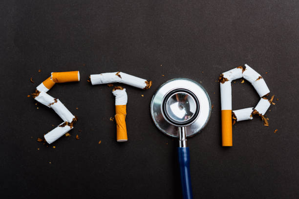 word STOP spelled text of the pile cigarette or tobacco 31 May of World No Tobacco Day, no smoking close up word STOP spelled text of the pile cigarette or tobacco and doctor stethoscope on black background with copy space, and Warning lung health concept anti tobacco day stock pictures, royalty-free photos & images