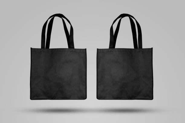 Mockup black tote bag fabric for shopping, mock up canvas bag textile with reusable. stock photo