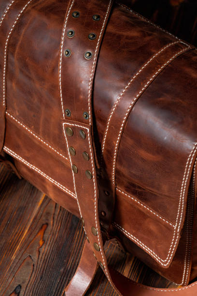 istock Retro style brown leather messenger bag with rivet straps 1318387406