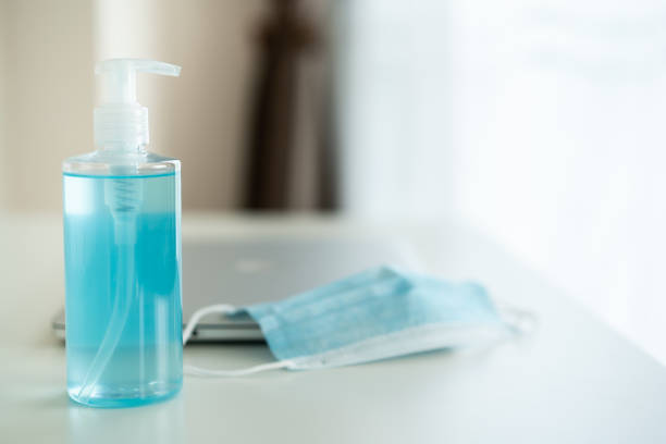 istock Protective hygiene facemask and alcohol gel hand sanitizer on the working table in office. 1318391499