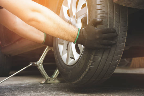 istock The mechanic's hand was pulling the alloy wheels 1318392971