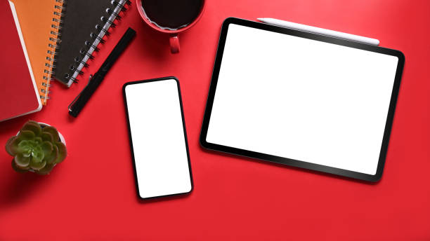 istock Mock up smart phone, digital tablet, coffee cup and notebook on red background. 1318395946