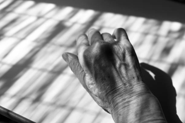 Right hand of senior lady with straw screen silhouette