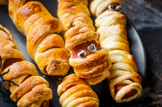 istock Funny sausage mummies in dough. Halloween treat 1318397662
