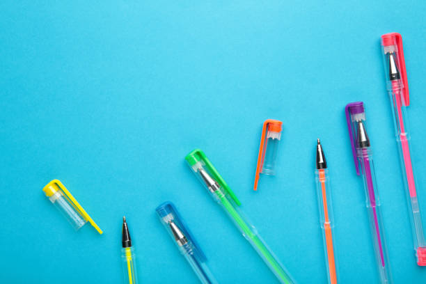 istock Different colors pens on blue background. Top view 1318398912