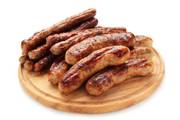 istock Roasted sausage on cutting board isolated on white background 1318398918