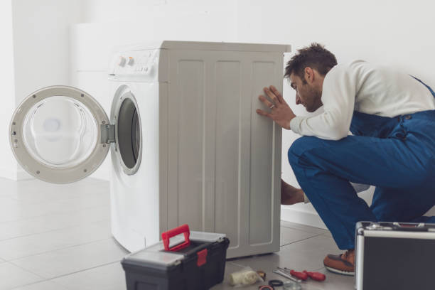 istock Professional repairman fixing a washing machine 1318400847