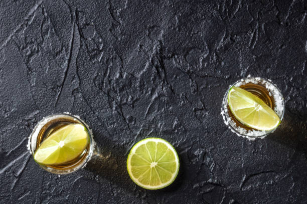 istock Tequila and limes, top shot on a dark background 1318400878