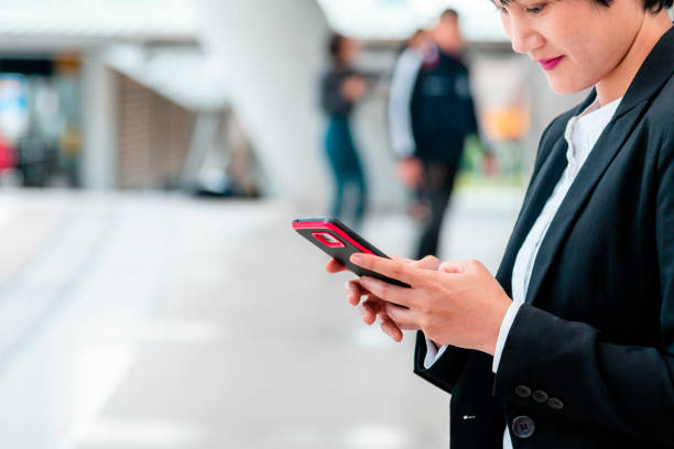 istock Business woman using smartphone shopping online, call, texting message internet technology lifestyle. Asian woman using cellphone walking on city street. Smart phone smart confident woman modern city 1318400893
