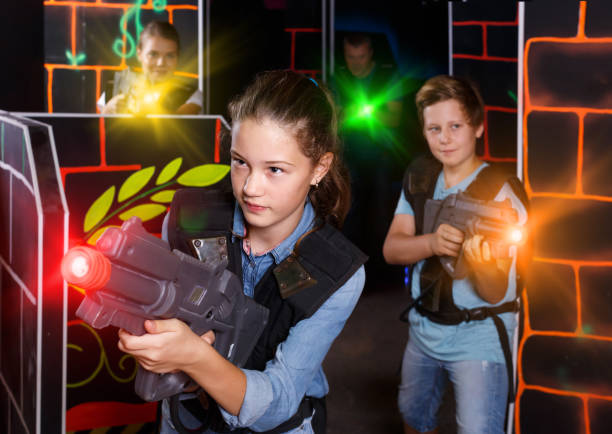 istock Nice girl aiming laser gun at other players 1318401762