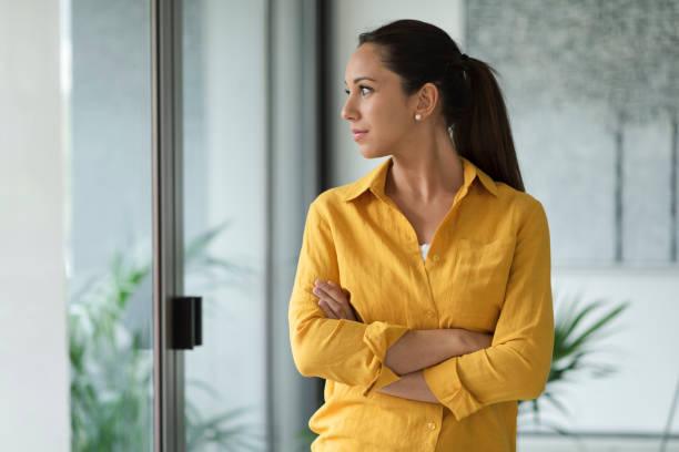 istock Young woman looking outside the window 1318402450