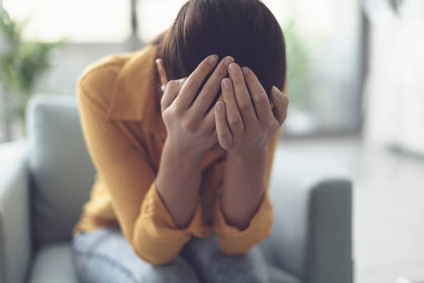 istock Young lonely woman crying at home 1318403006