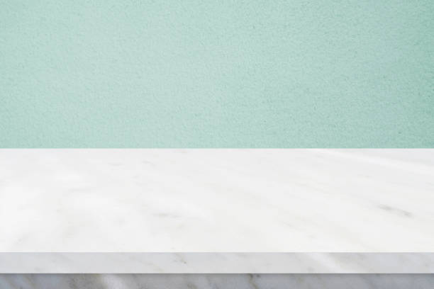 istock Perspective marble table surface and green wall background, Grey and white marble table top for kitchen product display background, Empty desk, shelf, counter for food and store backdrop, template 1318404577