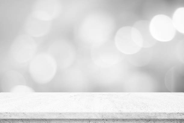 istock Empty white cement table over blur store background, product display montage, black and white tone, monochrome 1318405395