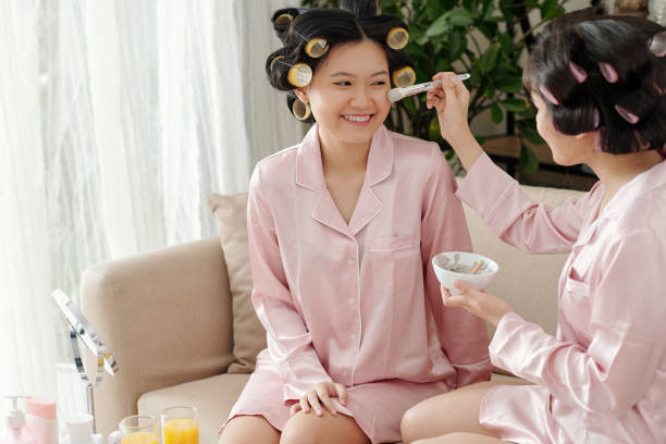 istock Women applying cleansing clay mask 1318406640