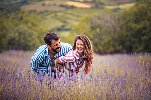 Young Couple in hug standing in lavender field.