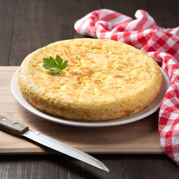 istock Traditional Spanish omelette with potatoes and onion on a dark rustic background. Spanish tapas. 1318406985