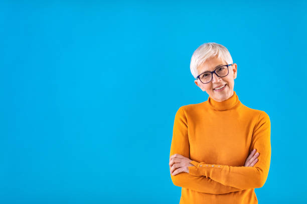 She creates her own opportunities Confident Mature Businesswoman Posing With Folded Arms Over Light Studio Background, Empty Space. Business Opportunities For Retirees. turtleneck photos stock pictures, royalty-free photos & images