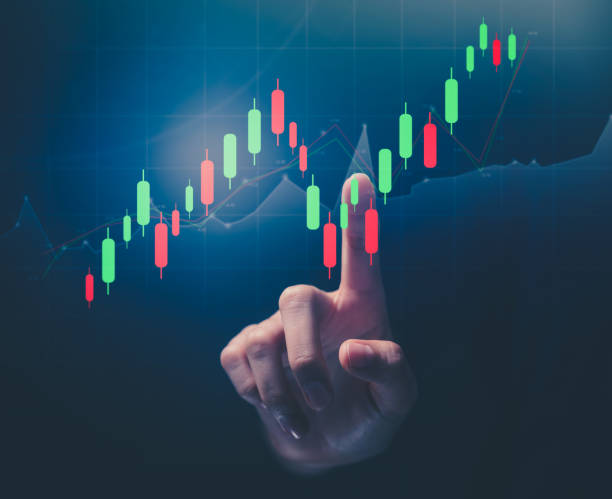 istock Stock exchange market concept, hand pointing on screen with graphs analysis candle line on bokeh colors light. 1318410811