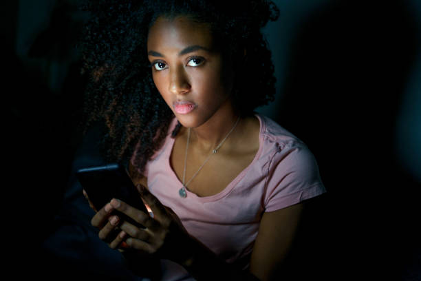 istock Lonely girl texting on mobile phone late at night 1318410938