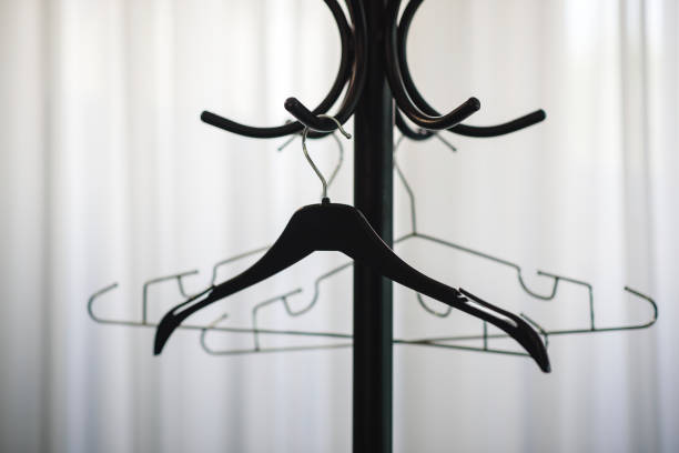 Empty clothes hangers on red background, flat lay. Space for text