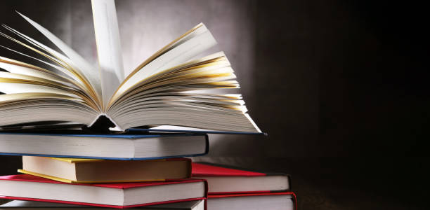 istock A composition with an open book lying on a stack of other books 1318423099
