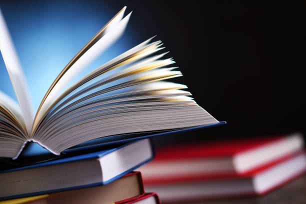 istock A composition with an open book lying on a stack of other books 1318423117