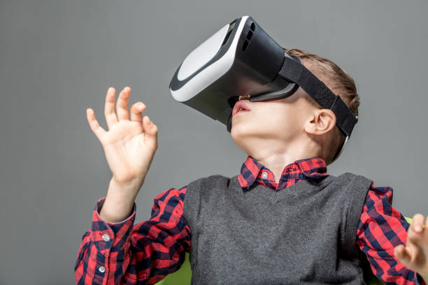 istock Boy in virtual reality glasses playing the game 1318423774