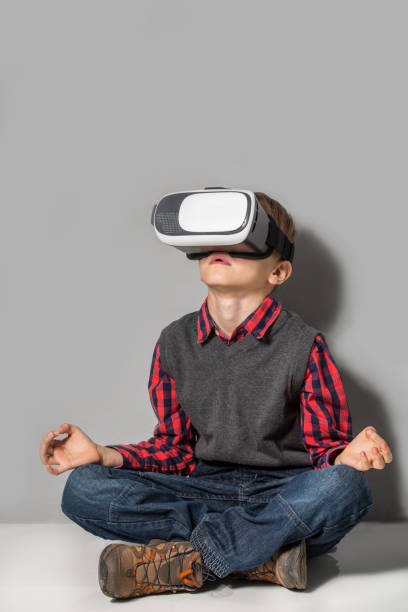 istock Boy in virtual reality glasses playing the game 1318423885