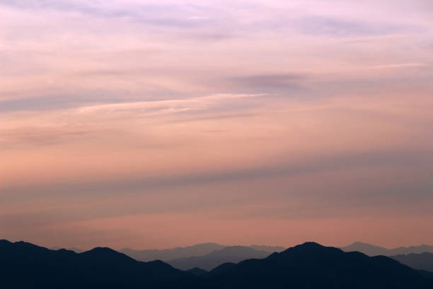 istock Sunset sky and silhouette mountains 1318426158