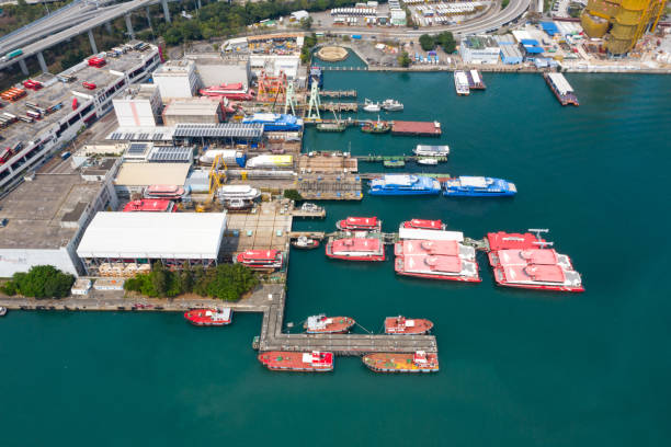 istock Shipbuilding construction ship in dry dock aerial view at shipyard harbour with scaffold 1318426891
