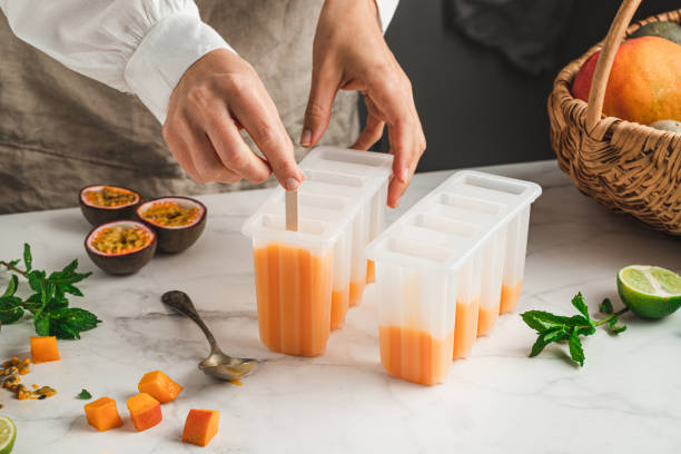 istock Hands of woman making popsicles at home 1318427056