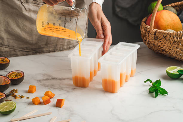istock Woman preparing mix fruit ice cream popsicles 1318427064