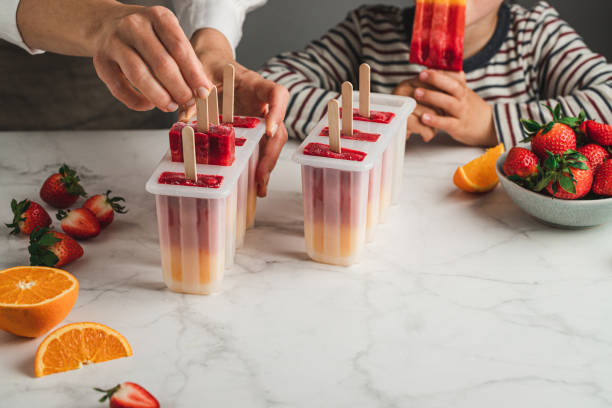 istock Mother preparing ice pops for her son 1318427102