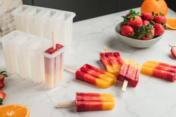 istock Frozen orange strawberry ice pops 1318427133