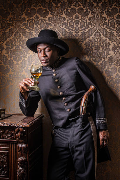 African traditionally dressed european man with a weapon Handsome traditional dutch black man wearing historically correct outfit holding a gun in a typical townhouse drawing room bounty hunter stock pictures, royalty-free photos & images