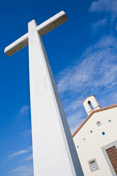 istock Christian high cross with small church against a dramatic sky 1318428046