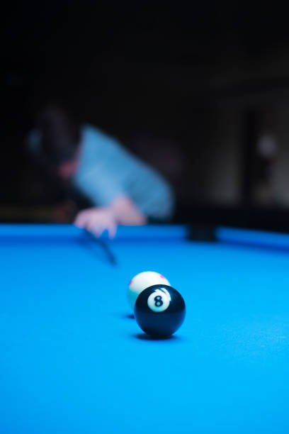 istock young man enjoying a game of billiards 1318428332