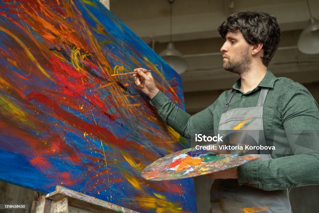 Man Is An Artist Holding A Brush And Drawing An Abstract Picture Stock  Photo - Download Image Now - iStock