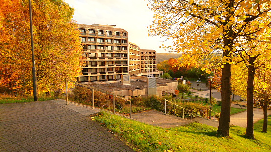 Colorful autumn landscape in Bad Ems. Rehabilitation clinic Lahntalklinik surrounded by trees with yellow leaves.