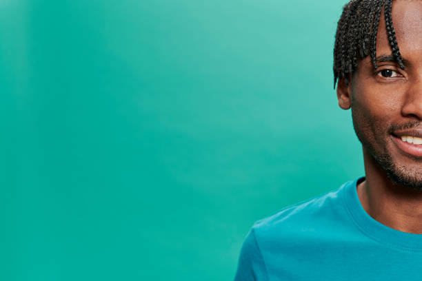 istock Young Black Wearing a blue t-shirt Over A Turquoise Background 1318430736