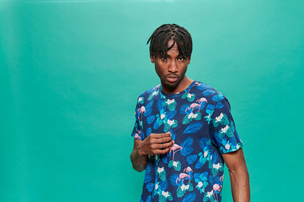 istock Young Black Wearing a printed t-shirt Over A Turquoise Background 1318430794
