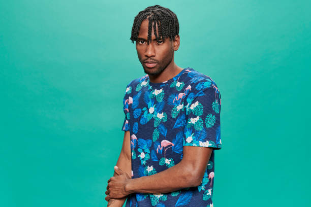 istock Young Black Wearing a printed t-shirt Over A Turquoise Background 1318430801