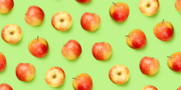 istock Red apple fruits over green seamless 1318431517