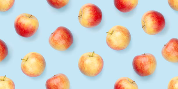 istock Red apple fruits over blue seamless 1318431560
