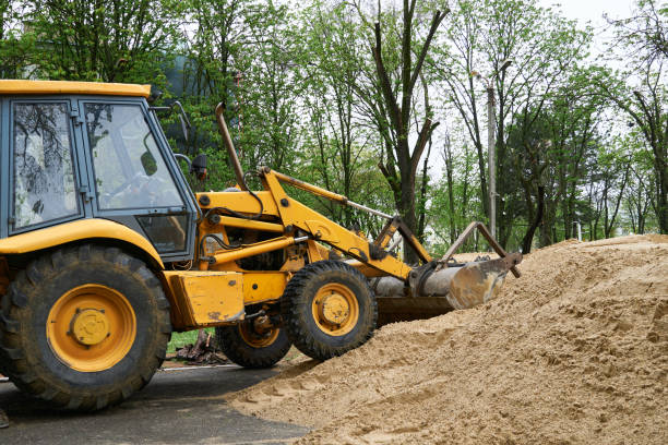 istock tractor or bulldozer works with a pile of sand for construction 1318432663