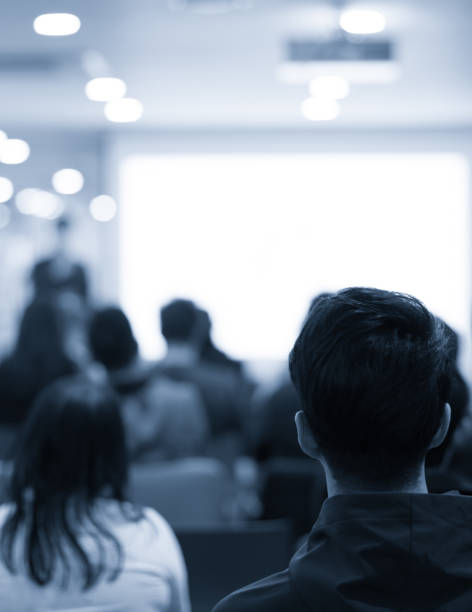 istock Conference photo audience and speaker giving speech. Seminar presenter at CEO forum. Real estate expert in training lecture. Investor pitch presentation workshop picture. 1318434320
